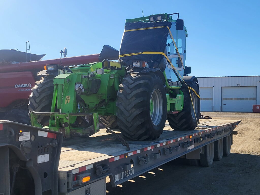 Hauling green tractor with attachment options on semi-trailer
