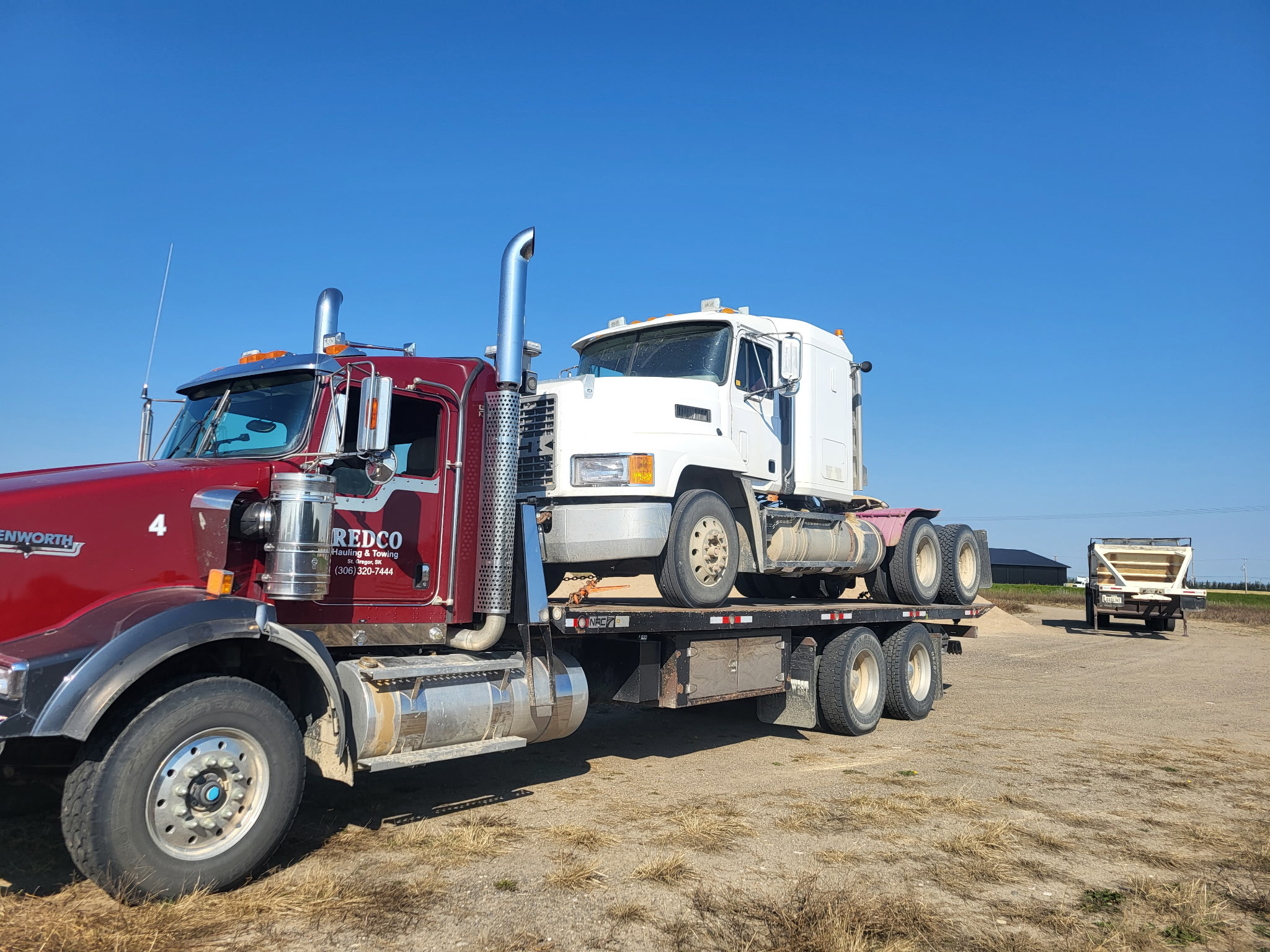 Deck truck with semi loaded from recovery